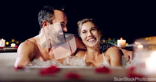 Image of Spa, love and couple in a jacuzzi happy, smile and relax one date night at a wellness resort. Zen, hot tub and man with woman laughing, peace and enjoying a romantic vacation, holiday or anniversary