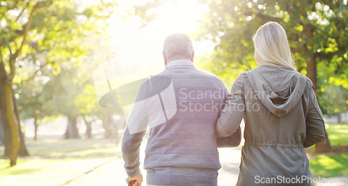 Image of Senior man, woman and walking outdoor in a park for support, love and care. Back of elderly father with a cane and daughter on walk for a healthy retirement, life insurance and family time in nature