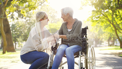 Image of Happy, wheelchair and a mother and woman in a park for support, bonding and talking. Smile, family love and an elderly mom with a disability and a girl in nature for conversation and happiness