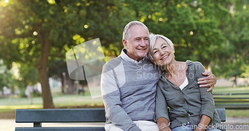 Image of Senior couple, bench and happy outdoor in a park with love, care and support in marriage. A elderly man and woman hug in nature with a smile for quality time, healthy retirement and freedom to relax