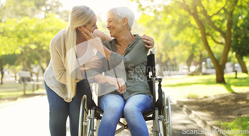 Image of Hug, woman and senior mother at the park, wheelchair and happiness with joy, weekend break or bonding. Family, mature parent or daughter embrace, outdoor or relax with a smile, disability or recovery