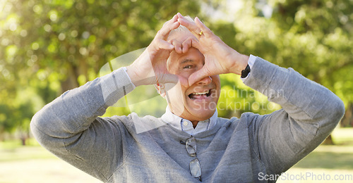 Image of Portrait, park and senior man with heart hands, happiness and support with review, retirement or relax. Face, mature male person or old guy with symbol for love, outdoor or happy with icon and nature
