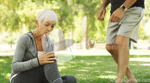 Image of Old couple, woman with knee pain and injury outdoor, fibromyalgia health problem and joint ache from exercise. Muscle tension, arthritis and people in retirement with fitness in park and emergency