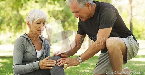 Image of Old couple, woman with knee pain and injury in park, fibromyalgia health problem and joint ache from exercise. Man helping, arthritis and people in retirement with fitness outdoor and muscle tension