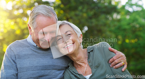 Image of Laughing, love and senior couple in a park together hugging with care, happiness and romance. Smile, nature and elderly man and woman in retirement embracing while sitting in an outdoor green garden.