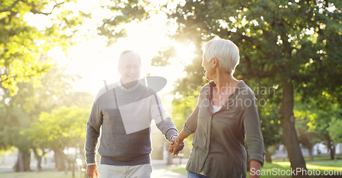 Image of Walking, holding hands and a senior couple outdoor at a park with a love, care and support. Elderly man and woman in nature to follow on a walk, quality time and happy marriage or healthy retirement