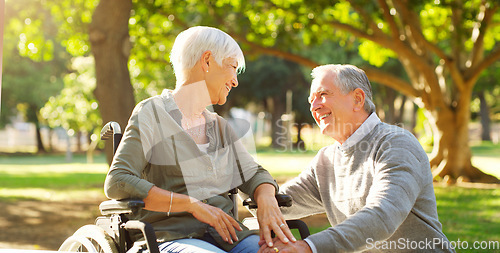 Image of Senior couple, wheelchair and happy outdoor at a park while talking with love, care and respect. A elderly man and woman with disability in nature for quality time, healthy marriage or retirement