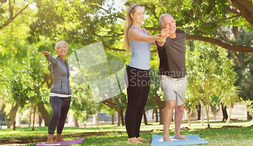 Image of Yoga, wellness and an old couple with their personal trainer in a park for a health or active lifestyle. Exercise, fitness or zen and senior people outdoor for a workout with their pilates coach