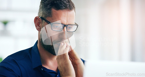 Image of Stress, challenge and laptop with a business man looking worried while working on a project in his office. Problem solving, bankruptcy and computer with an anxious male employee in doubt at work