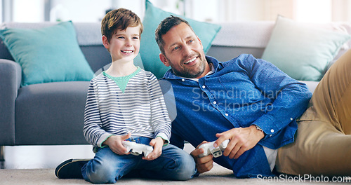 Image of Happy father, child and playing video games for fun bonding, holiday or weekend together on the living room floor at home. Dad and kid smiling in joyful happiness for console gaming or entertainment