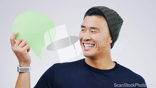 Image of Young asian man, speech bubble and studio with smile, opinion and social media with by background. Gen z guy, poster or paper sign for vote, review or mockup with happiness for ideas, news or chat