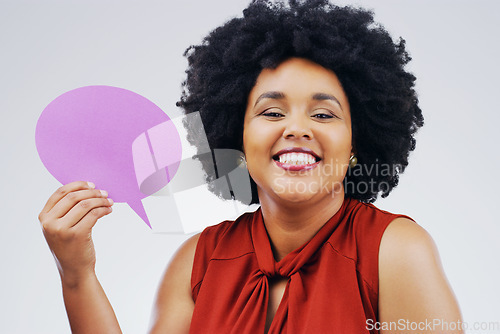 Image of Happy woman, portrait smile and holding speech bubble for question, FAQ or social media against a white studio background. Female person smiling with afro or sign for comment, message or mockup space
