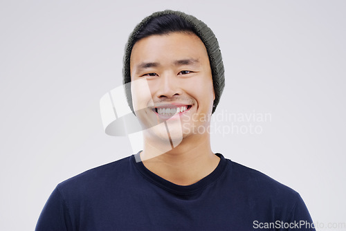 Image of Face portrait, smile and Asian man in beanie in studio isolated on a white background. Happy, handsome and male person from Japan with confidence, fashion and stylish aesthetic for positive mindset.
