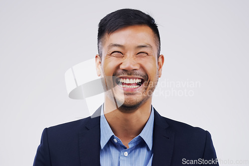 Image of Happy, laughing and portrait of businessman in a studio with comedy, comic joke or funny story. Happiness, smile and face of an Asian male person with a positive face expression by gray background.