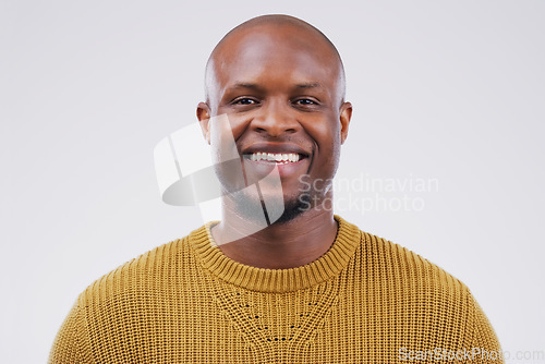 Image of Portrait, smile and black man with confidence, wellness and casual outfit against grey studio background. Face, male person and guy with happiness, carefree and joyful with mockup, beauty and fashion