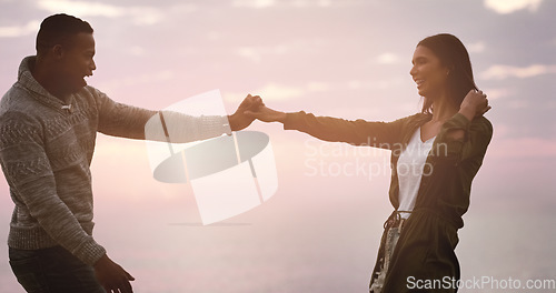 Image of Dancing, couple and sunset sky at beach for happy memory on vacation, holiday or adventure. A man and woman dance to celebrate love, marriage and travel journey or date with a smile outdoor in nature