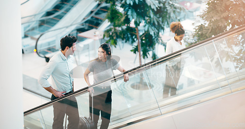 Image of Escalator, business people and staff talking, discussion and happiness with ideas, planning or chatting. Man, woman or coworkers in a modern office, conversation or communication on a moving stairway