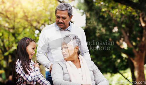 Image of Grandparents, park and old woman in wheelchair together with her husband and granddaughter. Person with a disability, family or kids and girl child bonding with her senior relatives in natural garden