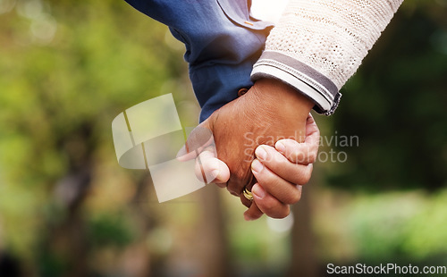 Image of Love, closeup senior couple holding hands and in a park nature background. Support or care, bonding or quality time and married old people outdoors together in a garden or in green environment.