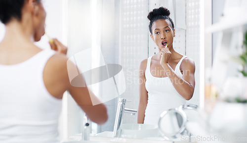 Image of Woman brushing teeth in bathroom, mirror with dental and oral hygiene with morning routine, toothbrush and health. Female person at home, grooming and self care with clean mouth and wellness
