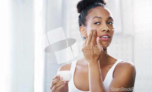 Image of Woman, face and mirror with cream for beauty, moisturizer and cosmetic product with morning routine in bathroom. Female person apply lotion to skin, skincare and dermatology at home with mockup space