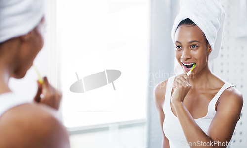 Image of Happy woman brushing teeth in bathroom, mirror and oral hygiene, morning routine with toothbrush and dental. Female person at home, grooming and self care, clean mouth with toothpaste and health