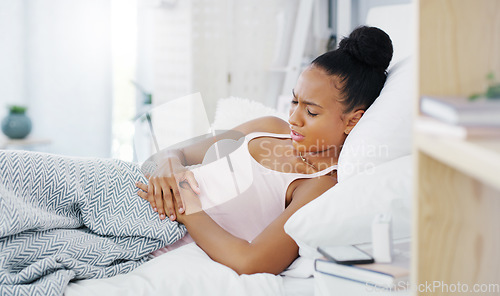 Image of Woman in bed, stomach pain and period cramps with endometriosis, health problem and sick. Female person with digestion issue, abdominal ache and menstruation with gastrointestinal emergency at home