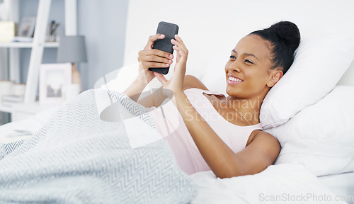 Image of Phone, happy and woman in bed with smile for social media post, internet humor and funny message. Communication, home and female African person in bedroom on smartphone mobile app, website and online