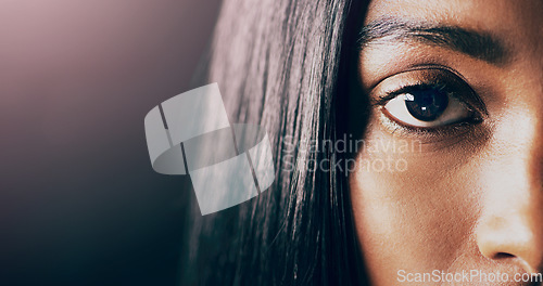 Image of Portrait, closeup and woman with mockup, eye and health against a dark studio background. Face, female person and model with focus, retina and clear vision with eyebrow, lashes and microblading