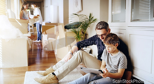 Image of Father, son and tablet, playing games and relax, break from unpacking and moving into new house. Man, boy and wireless tech with property, real estate and rest with video game online and bonding