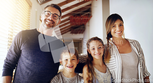 Image of Portrait, children and parents as a homeowner family moving house for a new start after real estate purchase. Mom, dad and kids with a group of people in the living room of their property investment