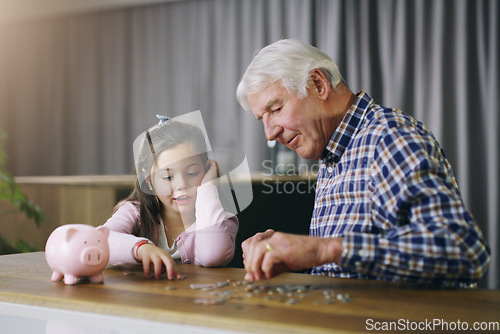 Image of Money, piggy bank and help with child and grandfather for savings, investment and learning. Growth, cash and future with young girl and old man in family home for generations, finance and support