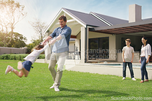 Image of Happy family, real estate and playing on grass together from holiday, weekend or break in the outdoors. Father swinging child on new home, lawn or property for fun time or play outside the house