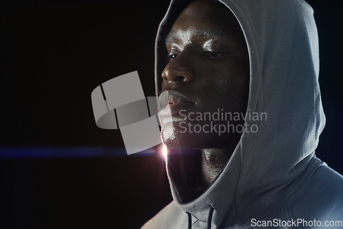 Image of Fitness, workout and face of black man with sweat in dark for running, exercise and marathon training. Sports mockup, thinking and serious male person in hoodie with dedication, motivation and focus