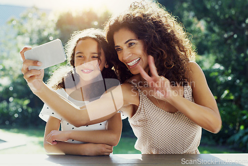 Image of Mother, girl kid and selfie in garden with peace sign, happiness or smile in summer sunshine. Young mom, daughter and profile picture for social media, app or blog in backyard with bond, love or care