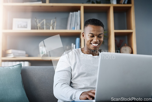 Image of Happy black man with laptop, streaming online and relax in living room, subscription service with internet and smile. Technology, connectivity and male person chill at home watching tv show or film