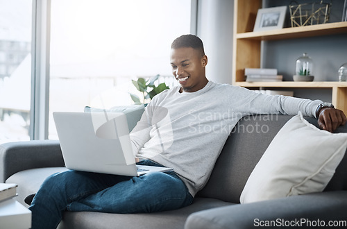 Image of Black man relax on couch with laptop, streaming online in living room and subscription service with internet. Technology, connectivity and happy male person chill at home watching tv show or film