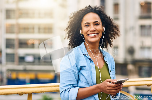 Image of Phone, music and portrait of woman in city with happiness listening to track, audio and song in urban town. Traveling, happy and African female person streaming radio for relaxing, chill and peace