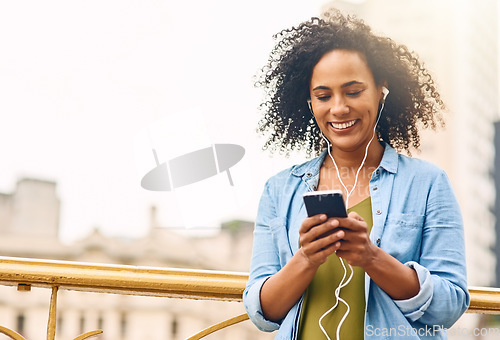 Image of Music, happy and woman in city with phone for happiness listening to track, audio and song in urban town. Traveling, mockup space and African female person smile streaming radio for relax on weekend