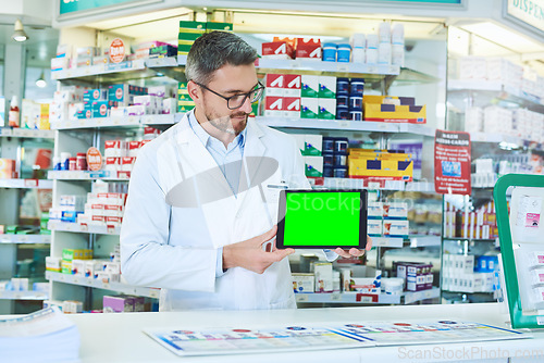 Image of Man, pharmacist and tablet with green screen with healthcare, store and mockup with pharmaceutical promo on app. Mature pharma expert, digital touchscreen and space with chromakey for mock up in shop