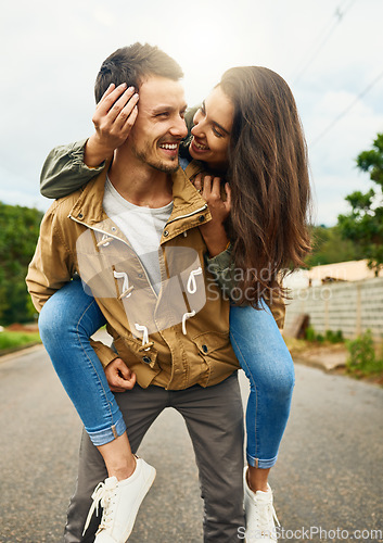 Image of Care, love and piggyback with couple in road for happy, smile and bonding. Happiness, relax and weekend with man carrying woman on countryside date for spring, anniversary vacation and support