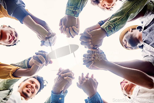 Image of Friends, support and people holding hands in circle for motivation, community and friendship outdoors. Teamwork, diversity and below of men and woman together for trust, commitment and solidarity