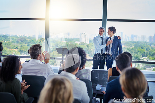 Image of Professional, presentation and applause during a seminar at the workplace with people in the audience. Business, employees and congratulations during conference for awards in career at the office.