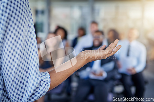 Image of Presentation, hand and a speaker coaching at a conference for training or workshop. Business, corporate and a woman manager speaking to a crowd at a seminar or convention for leadership or mentoring