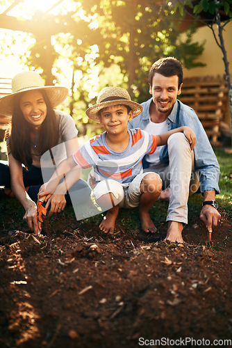 Image of Happy family, soil or plant in garden for sustainability, agriculture care or farming development. Backyard, learning natural growth or parents of boy child with sand or planting for teaching a child