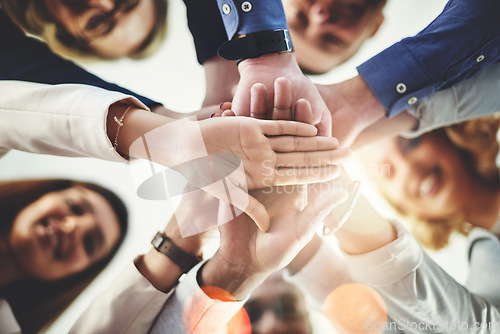 Image of Team, hands of colleagues together and smile with huddle for collaboration for goal with lens flare. Teamwork or cooperation, businesspeople or coworkers and happy people with hand for support