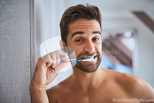 Image of Portrait, toothbrush and man brushing teeth in bathroom for dental wellness, healthy habit or gum care at home. Face, guy and cleaning mouth for fresh breath, oral hygiene or morning grooming routine