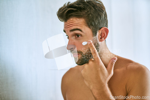 Image of Man, face and cream for skincare, beauty and sunscreen at home with mockup for morning routine, grooming and self care. Young guy, lotion and facial cosmetics for dermatology, clean skin and hygiene