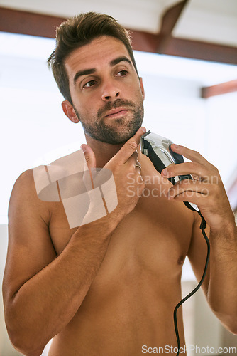 Image of Man, beard and shave with electrical razor for hair removal, aesthetic skincare and beauty cleaning in morning at home. Shirtless guy shaving face with blade, trimmer and cosmetic tools in bathroom