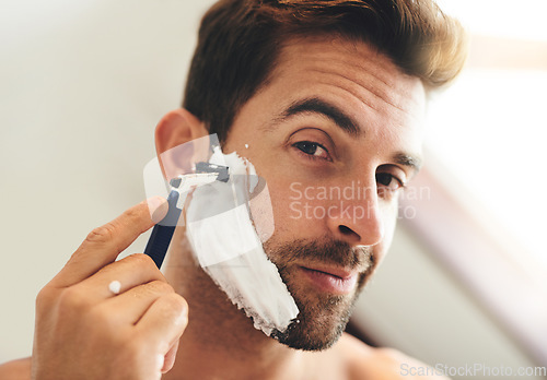 Image of Portrait, man and shaving face with razor for hair removal, aesthetic skincare and morning facial cleaning at home. Closeup of guy, foam and and shave with cream cosmetics, blade or beard in bathroom